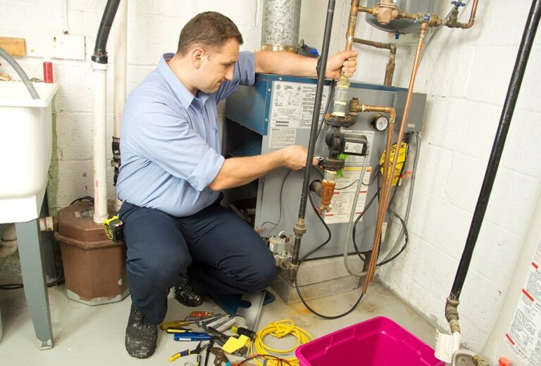 Technician installing a new furnace