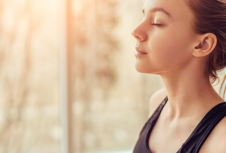 Woman breathing in fresh indoor air