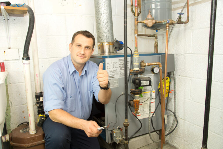 HVAC technician giving a thumbs up while working